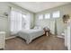 Light-filled bedroom with multiple windows and soothing green walls at 8406 Winter Berry Dr, Castle Pines, CO 80108
