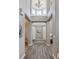 Grand foyer with soaring ceilings, hardwood floors, and elegant chandelier lighting the entrance at 8406 Winter Berry Dr, Castle Pines, CO 80108