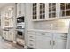 Bright kitchen with white cabinets, stainless steel appliances, and a tile backsplash at 8406 Winter Berry Dr, Castle Pines, CO 80108