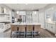 Spacious kitchen featuring a large island with seating, stainless appliances, and modern pendant lighting at 8406 Winter Berry Dr, Castle Pines, CO 80108