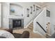 Cozy living room with a stone fireplace and staircase with a dark metal railing at 8406 Winter Berry Dr, Castle Pines, CO 80108