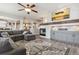 Open-concept living room featuring a fireplace, stylish rug, and comfortable seating at 8406 Winter Berry Dr, Castle Pines, CO 80108