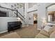Open-concept living room featuring a staircase, piano, and comfortable seating area at 8406 Winter Berry Dr, Castle Pines, CO 80108