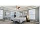 Bright main bedroom with tray ceilings, large windows, and neutral color scheme at 8406 Winter Berry Dr, Castle Pines, CO 80108
