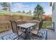 Outdoor patio on a deck with a dining set and an inviting blue rug at 8406 Winter Berry Dr, Castle Pines, CO 80108