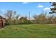 Large, grassy backyard with mature trees and potential for landscaping, ideal for outdoor activities at 784 W Sterne Pkwy, Littleton, CO 80120