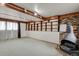 A large finished basement with wood accents and fireplace, and built-in wall shelving at 784 W Sterne Pkwy, Littleton, CO 80120