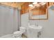 Cozy bathroom featuring knotty pine and white accents, including a pedestal sink at 784 W Sterne Pkwy, Littleton, CO 80120