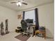 A home office area with computer, chair, dark curtains, and natural lighting from the window at 784 W Sterne Pkwy, Littleton, CO 80120
