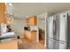 Well-lit kitchen with modern appliances, wood cabinets, and easy access to the dining area at 784 W Sterne Pkwy, Littleton, CO 80120