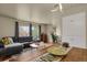 Open concept living space featuring a modern sofa, dining table, and stylish decor at 784 W Sterne Pkwy, Littleton, CO 80120
