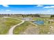 Expansive property with a meandering driveway leading to a house and pond amidst a picturesque, natural landscape at 15295 E Cherry Creek S Rd, Larkspur, CO 80118
