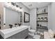 Stylish bathroom featuring double sinks, modern fixtures, and decorative shelving at 15295 E Cherry Creek S Rd, Larkspur, CO 80118