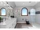 A luxurious bathroom featuring a double vanity with marble countertops, modern fixtures, and a glass-enclosed shower at 15295 E Cherry Creek S Rd, Larkspur, CO 80118