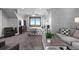 A charming bedroom with carpeted floors, a cozy sitting area, and a large window showcasing scenic outdoor views at 15295 E Cherry Creek S Rd, Larkspur, CO 80118