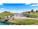 Charming residence featuring a covered porch, a nearby pond with a dock, and a well-manicured lawn at 15295 E Cherry Creek S Rd, Larkspur, CO 80118