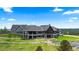 Stunning home with a stone facade, expansive windows, a yard, and a serene water feature at 15295 E Cherry Creek S Rd, Larkspur, CO 80118