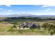 Expansive mountain home with lush green surroundings and a large driveway at 15295 E Cherry Creek S Rd, Larkspur, CO 80118