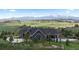 Beautiful home with a water feature, set against a backdrop of majestic mountains and green hills at 15295 E Cherry Creek S Rd, Larkspur, CO 80118