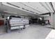 Spacious garage with multiple vehicles and overhead lighting at 15295 E Cherry Creek S Rd, Larkspur, CO 80118