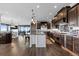 Stylish kitchen with dark wood cabinets, stainless steel appliances, and an open floor plan at 15295 E Cherry Creek S Rd, Larkspur, CO 80118