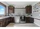Spacious laundry room with modern appliances, custom cabinetry, and a convenient countertop for folding clothes at 15295 E Cherry Creek S Rd, Larkspur, CO 80118