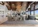 Cozy living room with a fireplace, high ceilings, and large windows showcasing scenic views at 15295 E Cherry Creek S Rd, Larkspur, CO 80118