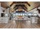 Elegant living room with a stone fireplace, wood ceiling and an abundance of natural light at 15295 E Cherry Creek S Rd, Larkspur, CO 80118