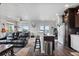 Open-concept living space featuring modern kitchen with stainless steel appliances and comfortable seating area at 15295 E Cherry Creek S Rd, Larkspur, CO 80118
