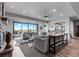 The spacious living room flows to an outdoor patio and an integrated bar, perfect for relaxing and entertaining at 15295 E Cherry Creek S Rd, Larkspur, CO 80118