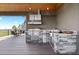 Outdoor kitchen with stone finishes, stainless steel appliances, and a scenic view at 15295 E Cherry Creek S Rd, Larkspur, CO 80118