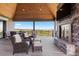 Inviting outdoor patio with a stone fireplace, comfortable seating, and picturesque views at 15295 E Cherry Creek S Rd, Larkspur, CO 80118