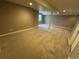 Finished basement featuring neutral carpet and paint colors, with architectural columns at 4746 Raven Run, Broomfield, CO 80023