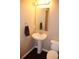 Charming bathroom with pedestal sink, mirror, and stylish towel rack at 4746 Raven Run, Broomfield, CO 80023