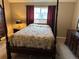Cozy bedroom featuring a four-poster bed, matching dressers, and bright window at 4746 Raven Run, Broomfield, CO 80023