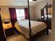 Cozy bedroom featuring a four-poster bed, ample natural light, and neutral decor at 4746 Raven Run, Broomfield, CO 80023
