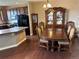 Elegant dining area featuring hardwood floors, a large table, and classic china cabinet at 4746 Raven Run, Broomfield, CO 80023