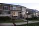 Charming townhome featuring stone accents, covered entry, and well-maintained landscaping at 4746 Raven Run, Broomfield, CO 80023