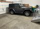 Spacious two car garage with gray Jeep parked inside on a painted concrete floor at 4746 Raven Run, Broomfield, CO 80023