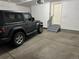 Attached garage featuring space for parking and a small stairway leading up to a door at 4746 Raven Run, Broomfield, CO 80023