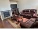 Inviting living room featuring a fireplace, entertainment center, and comfortable leather furniture at 4746 Raven Run, Broomfield, CO 80023