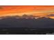 Breathtaking mountain views with a vibrant orange sunset over the majestic peaks in the distance at 4746 Raven Run, Broomfield, CO 80023