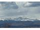 Mountain view of snow capped peaks underneath a blue sky with clouds in the distance at 4746 Raven Run, Broomfield, CO 80023