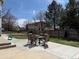 Backyard features a concrete patio with outdoor dining set and mature trees at 2050 Lake Circle Dr, Thornton, CO 80241