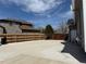 Large, concrete backyard patio area with partial fencing at 2050 Lake Circle Dr, Thornton, CO 80241