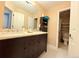 Well-lit bathroom featuring a double vanity, ample storage, and a separate toilet area at 2050 Lake Circle Dr, Thornton, CO 80241