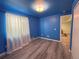 Bright bedroom featuring an unusual blue ceiling and walls and light-colored wood-look floors at 2050 Lake Circle Dr, Thornton, CO 80241