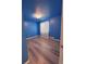 Cozy blue bedroom with wood-look flooring and bright natural light at 2050 Lake Circle Dr, Thornton, CO 80241