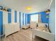 Bright bedroom features white furniture, new floors, and a striped blue wall at 2050 Lake Circle Dr, Thornton, CO 80241