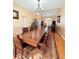 Spacious dining room featuring a large wooden table, hardwood floors and a stylish bar area at 2050 Lake Circle Dr, Thornton, CO 80241